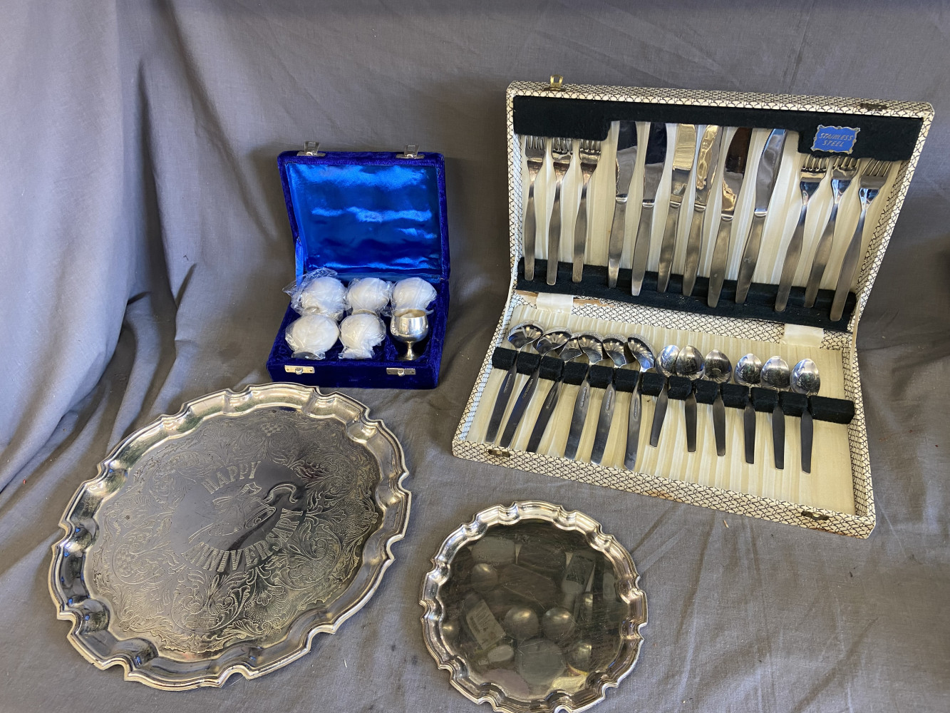 6 Silver plated egg cups, 2 metal plates and cutlery set box a/f