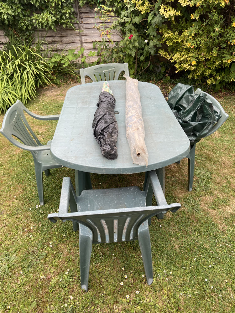 Garden table and 4 chairs and two parasols